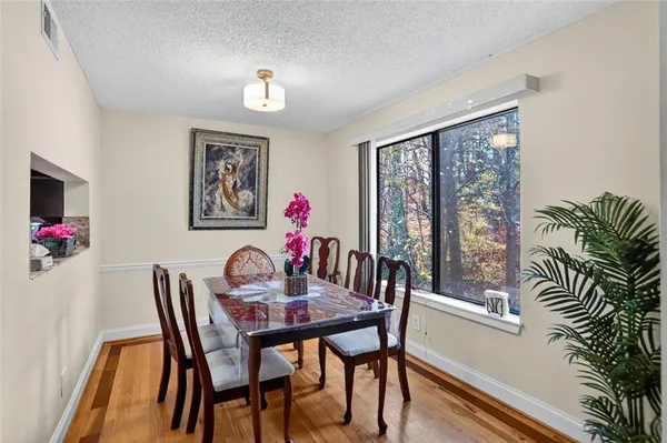 a view of a dining room with furniture window and wooden floor