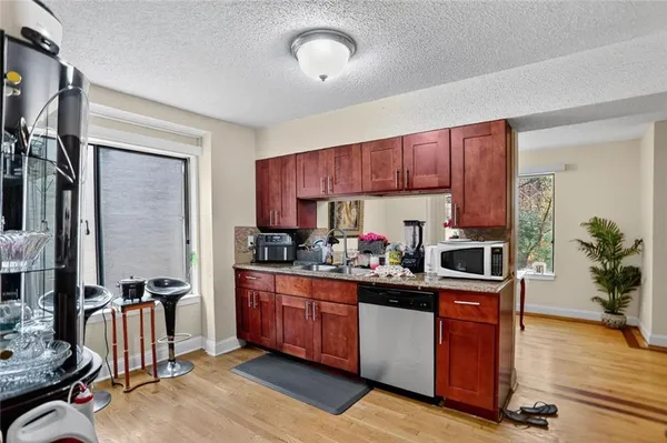 a kitchen with sink cabinets and wooden floor