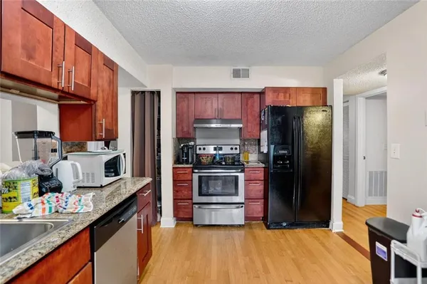 a kitchen with stainless steel appliances a refrigerator and a sink