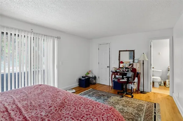 a bedroom with furniture and a wooden floor
