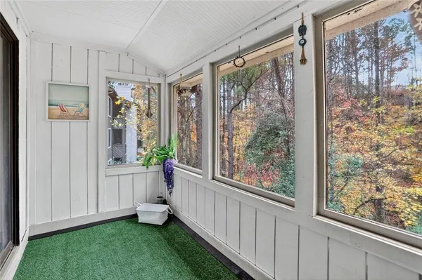 a view of a room with a large window and front door