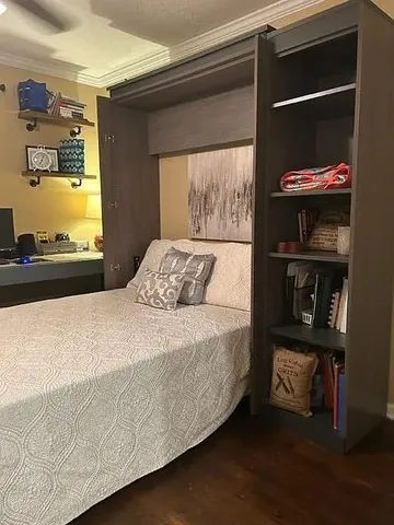 a bedroom with a bed and a window