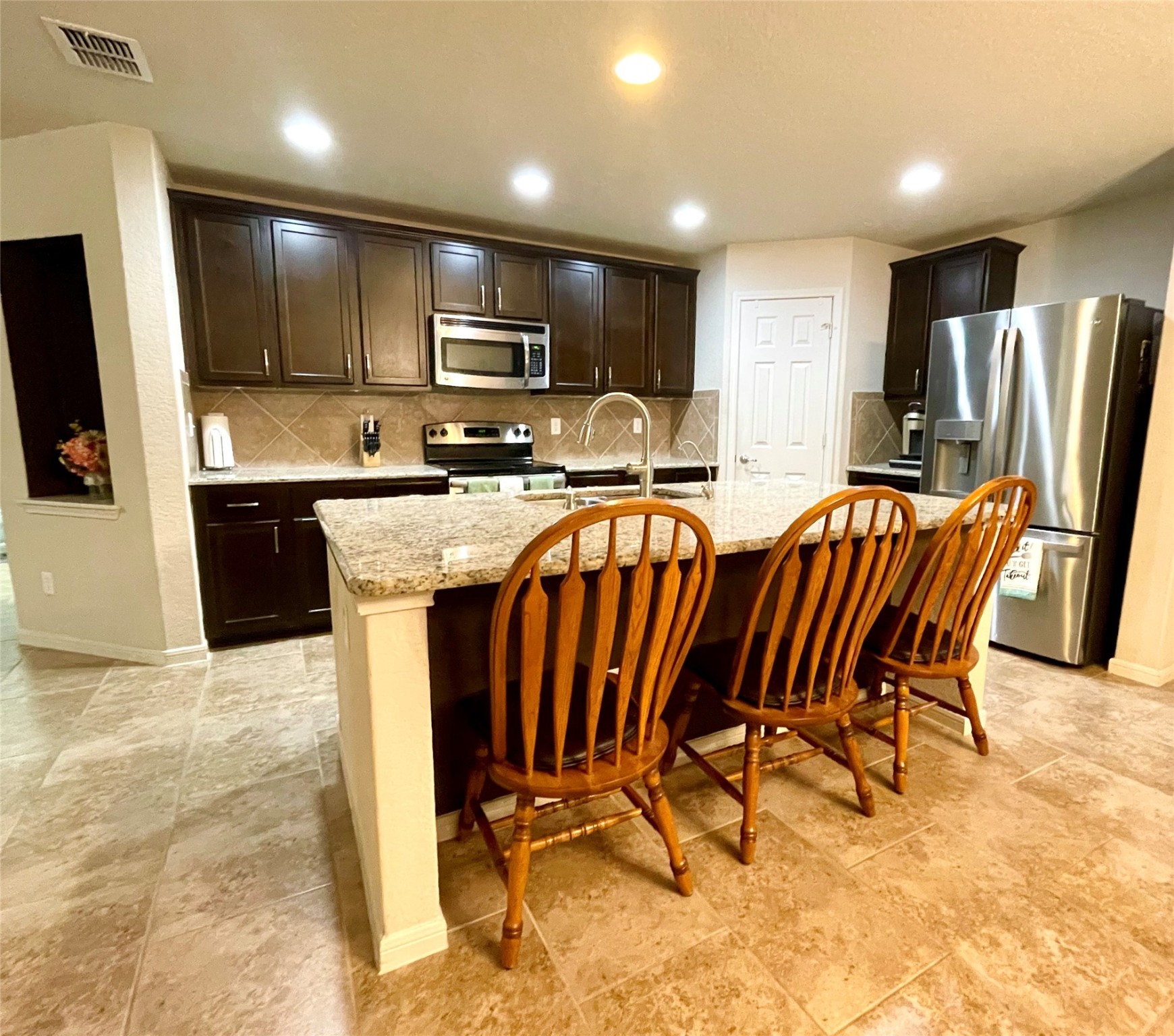 153 Citori Path New Braunfels, TX 78130 - Photo 3 of 12 a view of kitchen with cabinets stainless steel appliances dining table and chairs