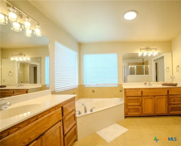 a spacious bathroom with a large tub and sink