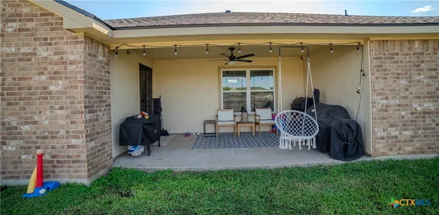 a view of a backyard with a patio and a tub