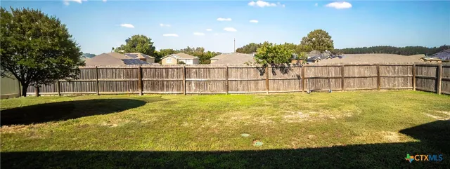 a view of swimming pool with an outdoor seating and yard