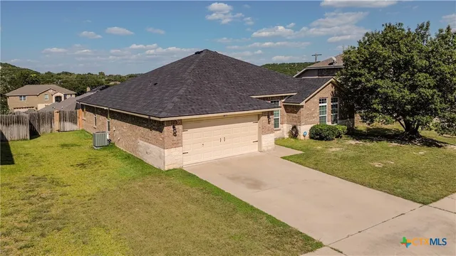 a aerial view of residential houses with yard and mountain view in back