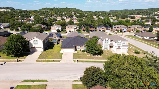 an aerial view of residential houses with outdoor space