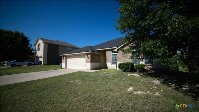 a view of a house with a yard and garage