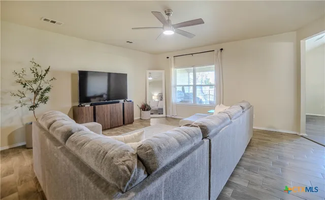 a living room with furniture and a flat screen tv