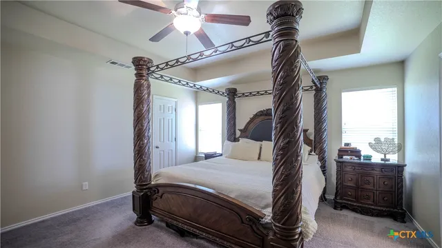 a bedroom with a bed and a mirror