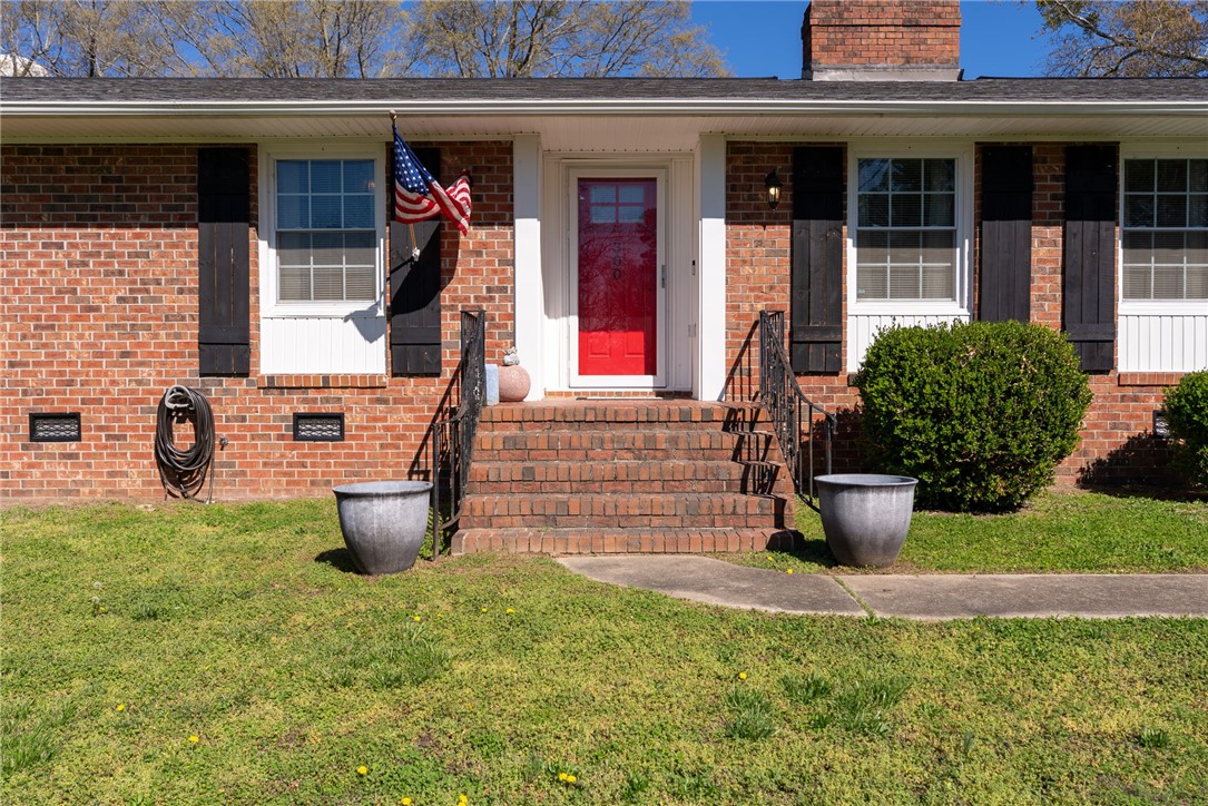 300 Green Street Williamston, SC 29697 - Photo 46 of 47 Welcome to a charming brick home featuring a vibrant red entry door.