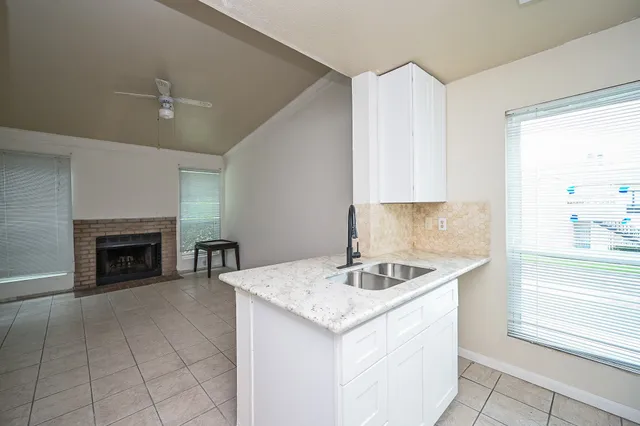 a kitchen with a sink stove and cabinets