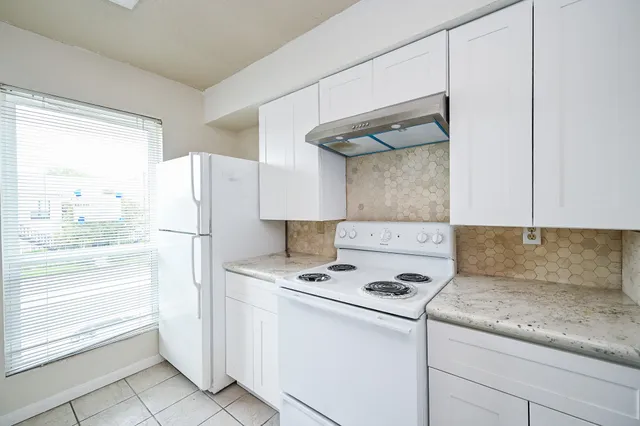 a kitchen with appliances cabinets and a counter top space