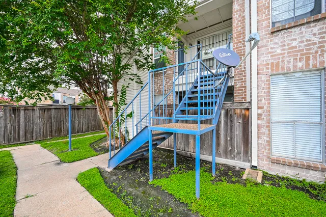 a view of a chair and table in the backyard