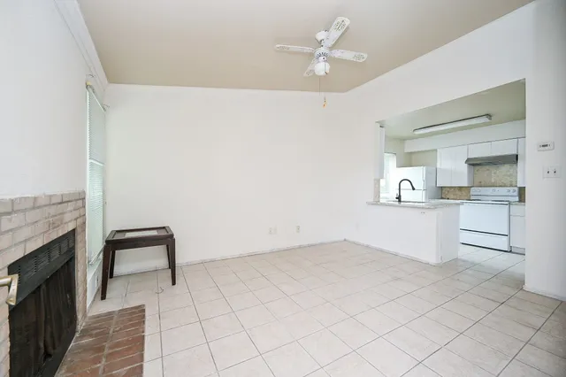 a view of kitchen with granite countertop cabinets and white appliances