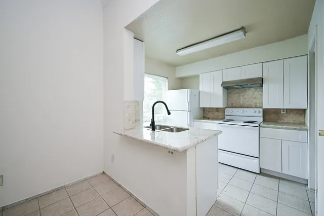 a kitchen with a sink cabinets and appliances