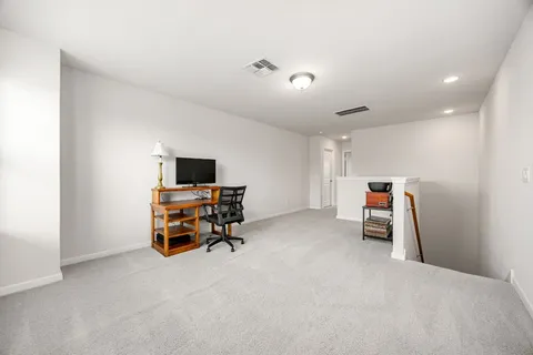 an empty room with mirror and window