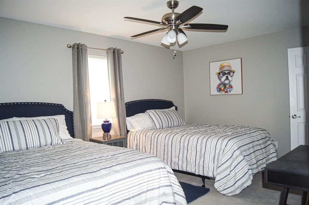 1727 Pueblo Street Dallas, TX 75212 - Photo 17 of 27 a bedroom with a large bed and a chandelier