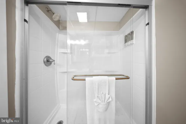 a bed room with a bed and a view of kitchen