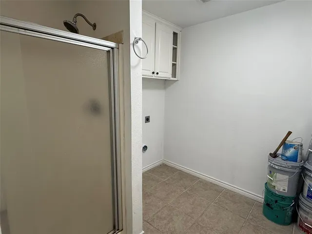 a bathroom with a granite countertop sink and shower