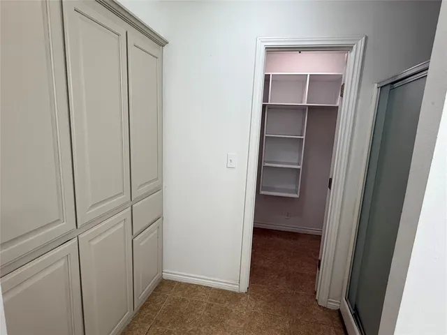 a bathroom with a granite countertop sink a toilet and a mirror