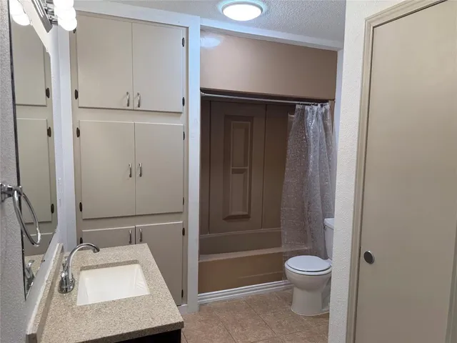 a bathroom with a sink vanity and a mirror