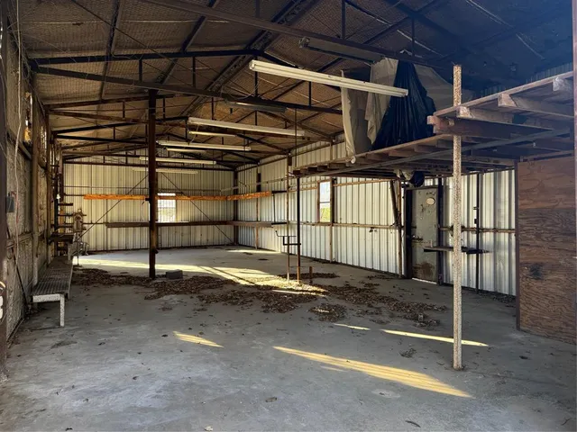 a view of empty room with wooden walls