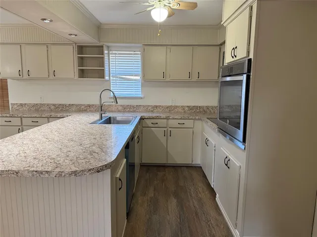 a kitchen with a sink a stove a refrigerator and cabinets