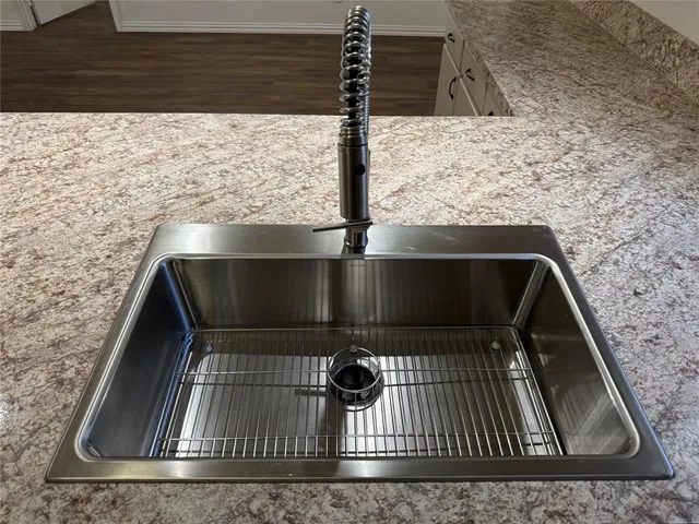 a kitchen with stainless steel appliances granite countertop a sink stove and cabinets