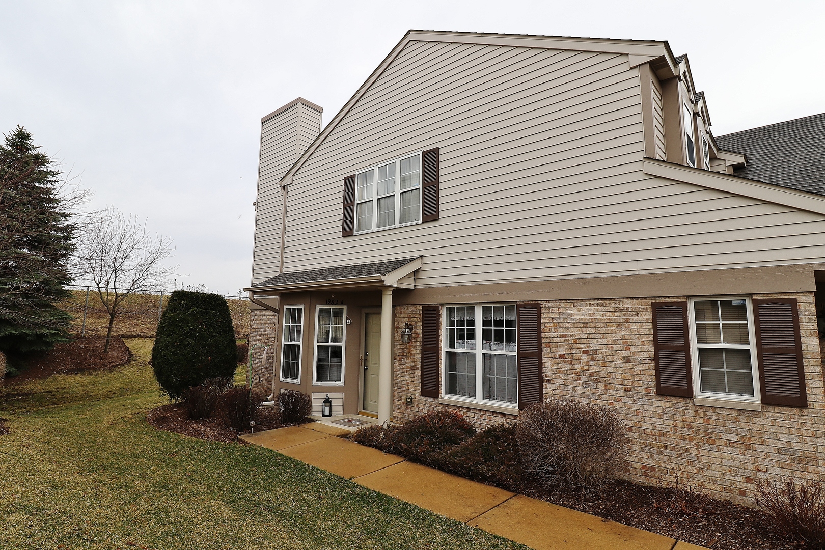 1982 Gary Court, Unit A Schaumburg, IL 60193 - Photo 2 of 21 a front view of a house with a yard
