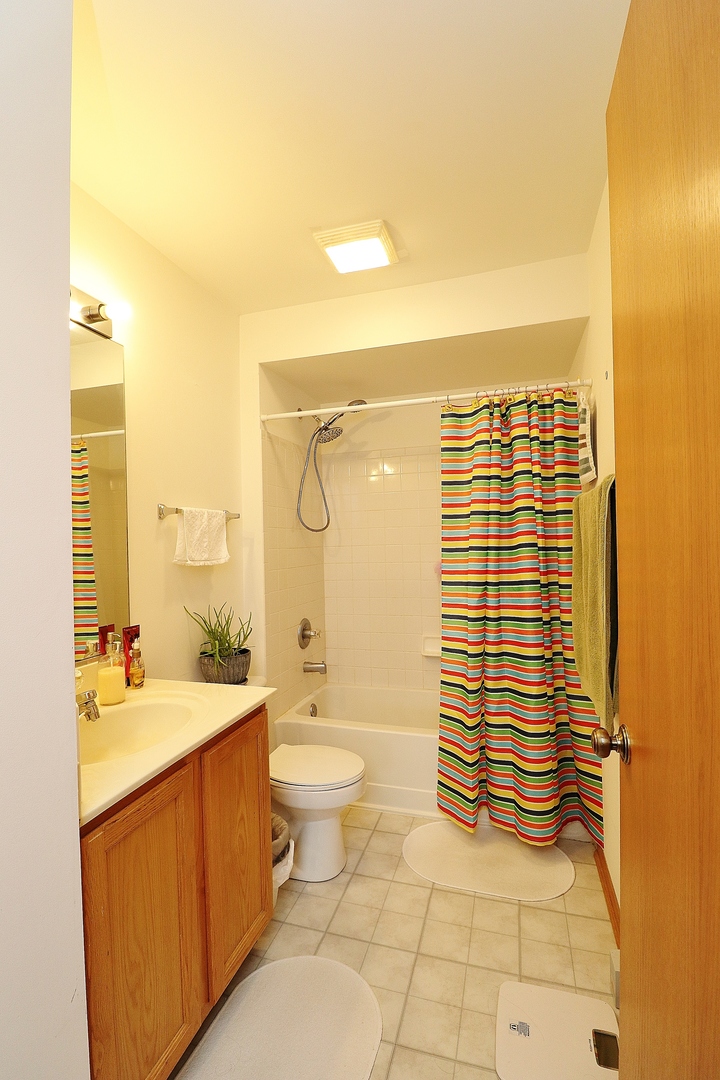 1982 Gary Court, Unit A Schaumburg, IL 60193 - Photo 12 of 21 a bathroom with a sink a toilet and shower