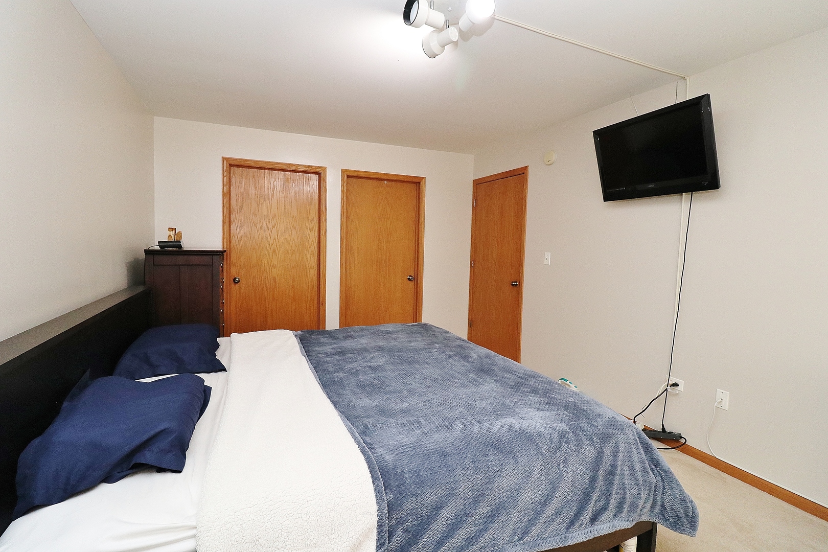 1982 Gary Court, Unit A Schaumburg, IL 60193 - Photo 15 of 21 a bedroom with a bed and a flat screen tv