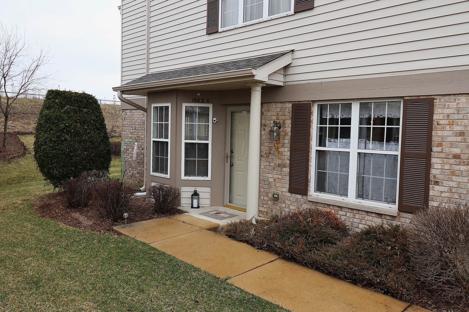 1982 Gary Court, Unit A Schaumburg, IL 60193 - Photo 3 of 21 a front view of a house with garden
