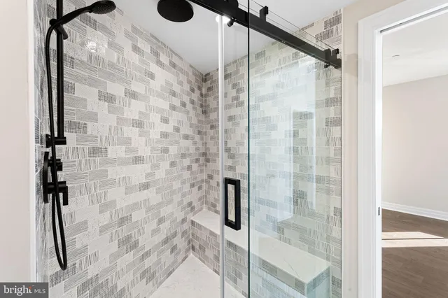 a view of an empty room with wooden floor and closet