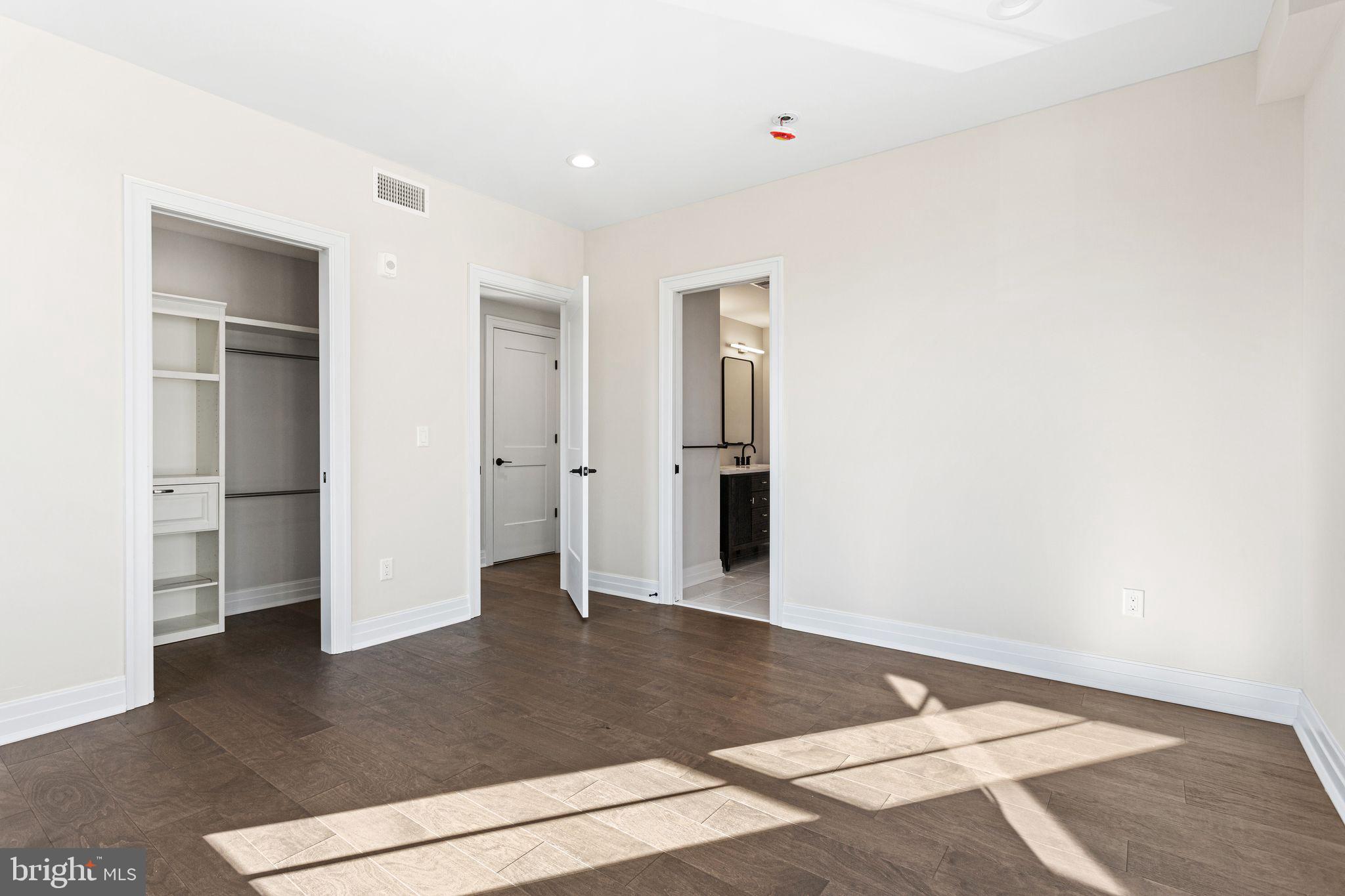 151 Kings Highway East, Unit B Haddonfield, NJ 08033 - Photo 13 of 23 a view of an empty room with wooden floor and closet