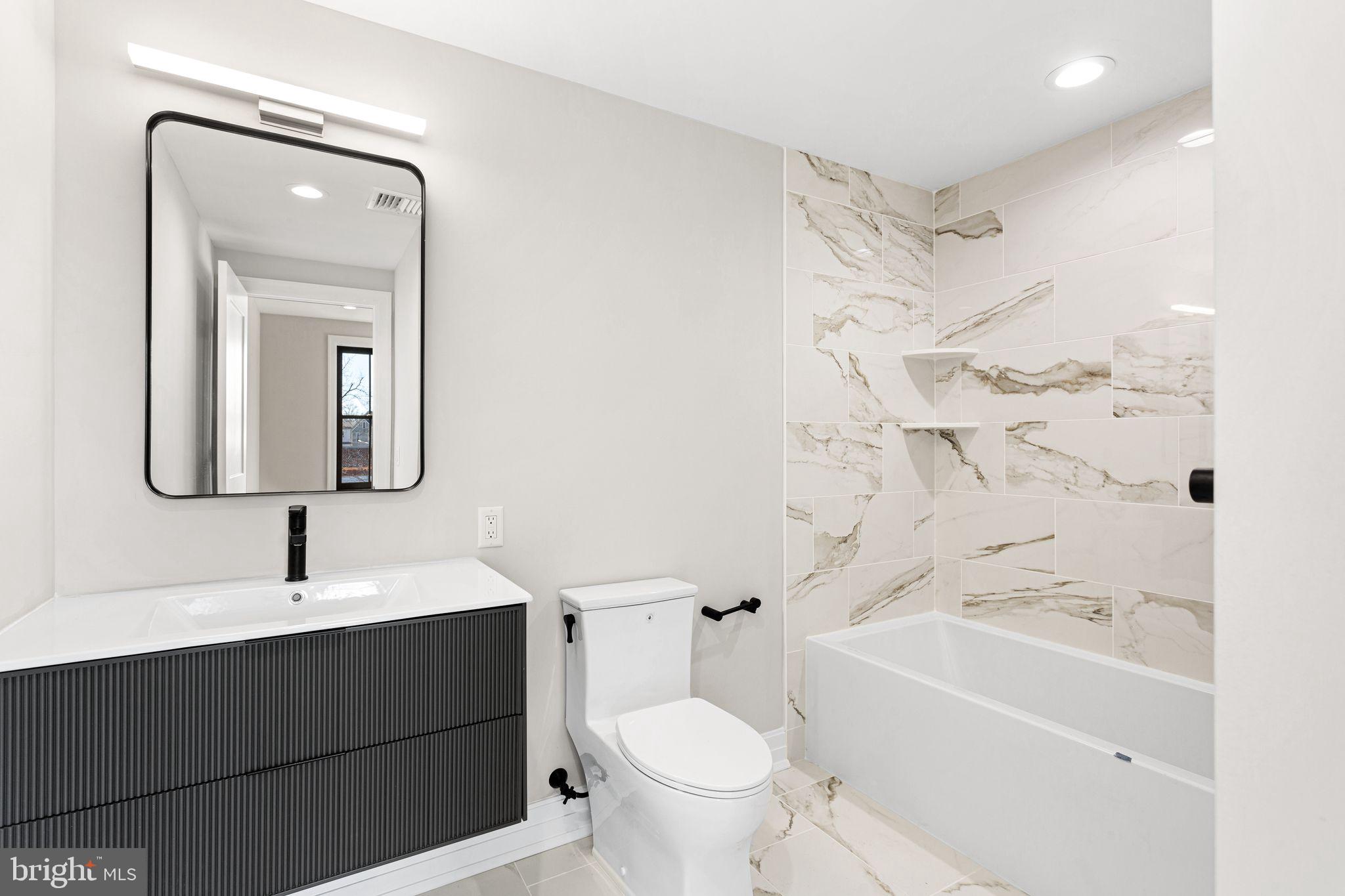 151 Kings Highway East, Unit B Haddonfield, NJ 08033 - Photo 18 of 23 a bathroom with a bathtub sink mirror and toilet