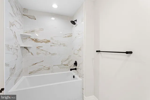 a bathroom with a sink mirror and toilet