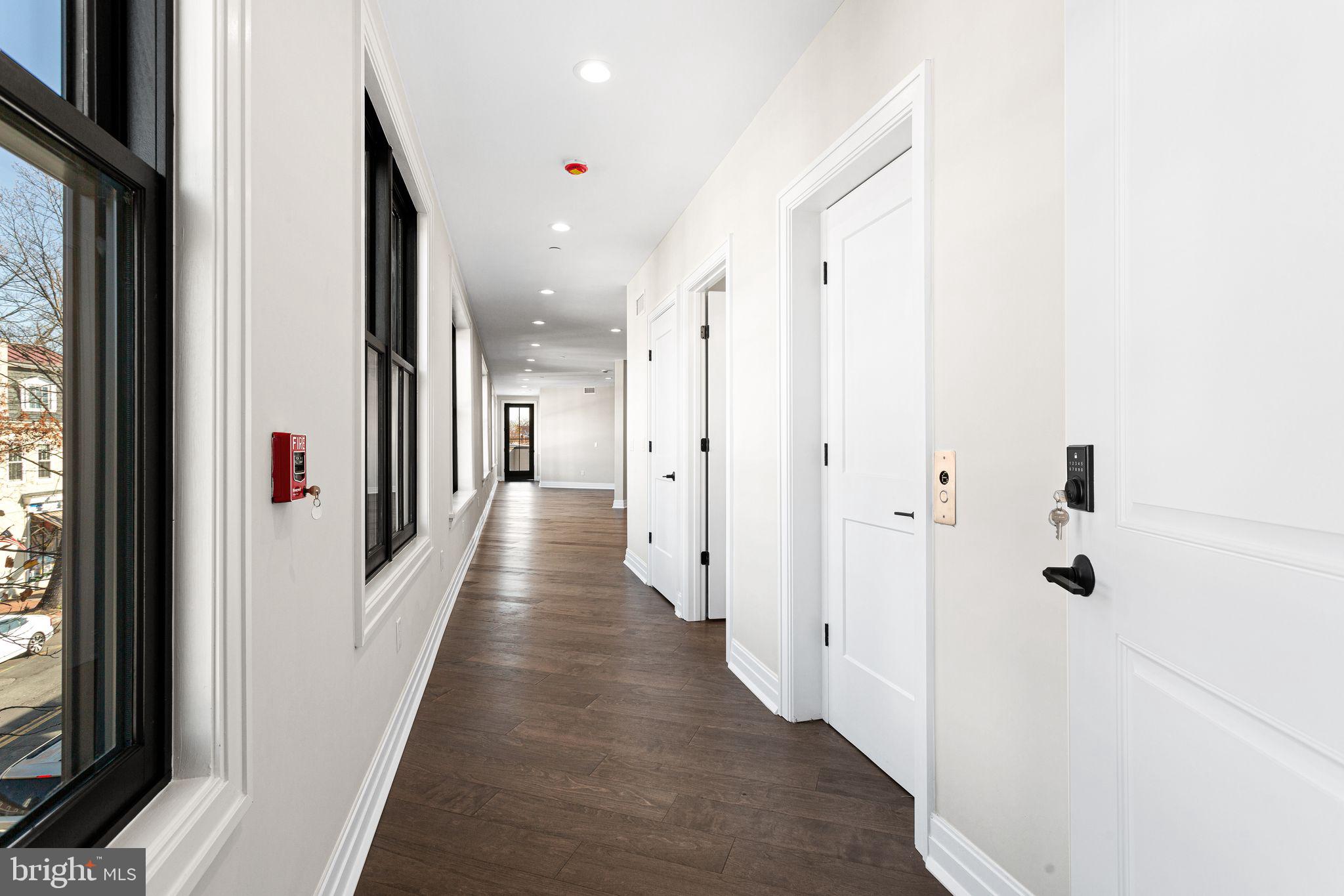 151 Kings Highway East, Unit B Haddonfield, NJ 08033 - Photo 22 of 23 a view of a hallway with wooden floor and a large mirror
