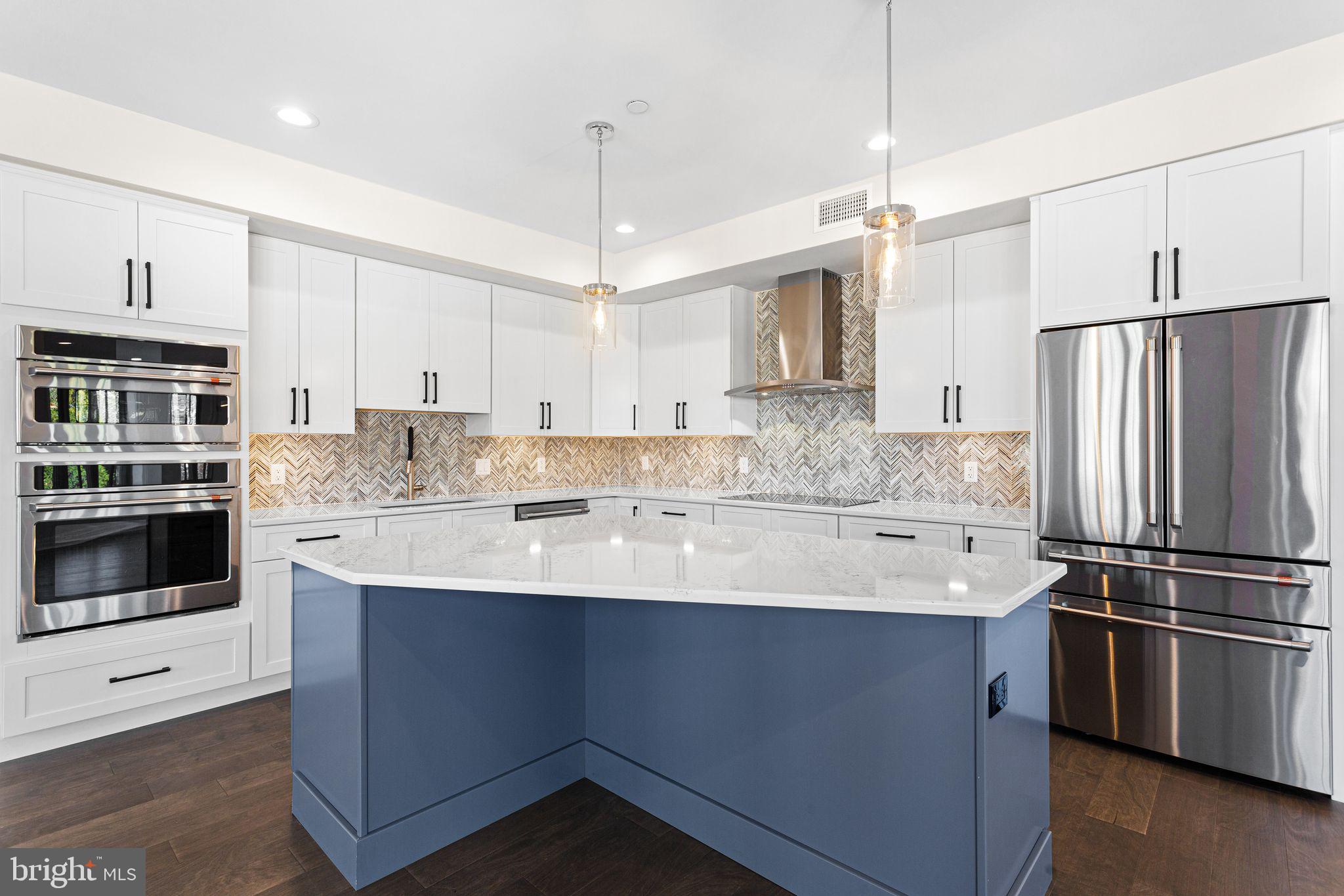 151 Kings Highway East, Unit B Haddonfield, NJ 08033 - Photo 3 of 23 a kitchen with stainless steel appliances kitchen island a sink and refrigerator