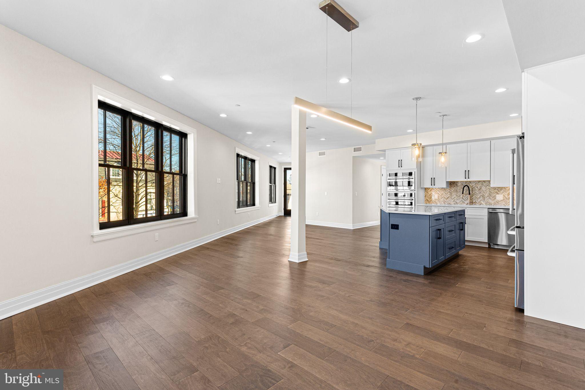 151 Kings Highway East, Unit B Haddonfield, NJ 08033 - Photo 6 of 23 a living room with stainless steel appliances kitchen island hardwood floor and a large window