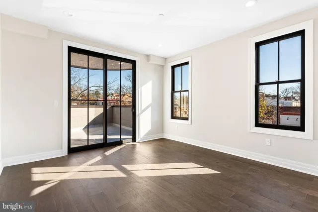 a bathroom with a granite countertop sink a toilet and shower
