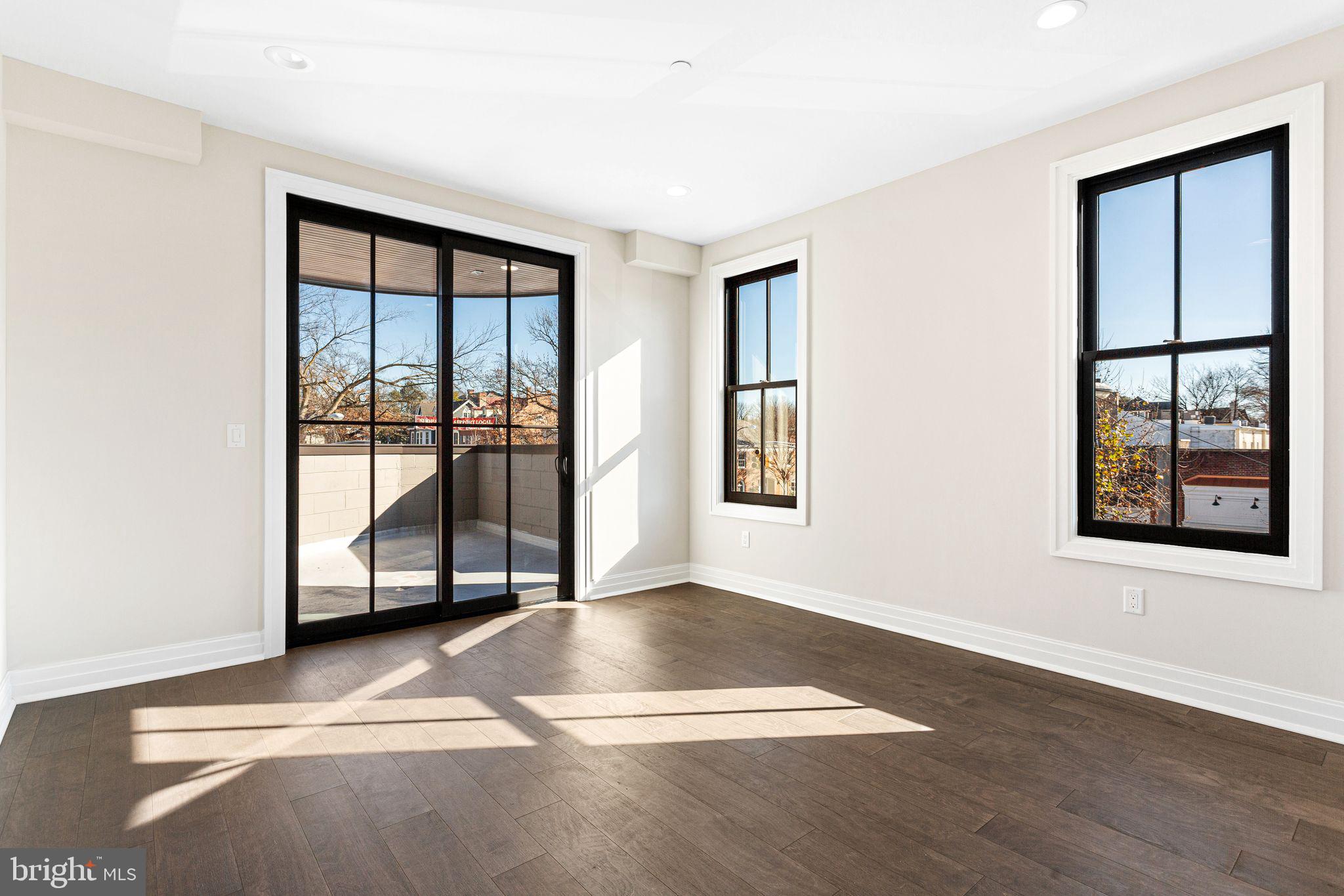 151 Kings Highway East, Unit B Haddonfield, NJ 08033 - Photo 9 of 23 a view of an empty room with a window and wooden floor