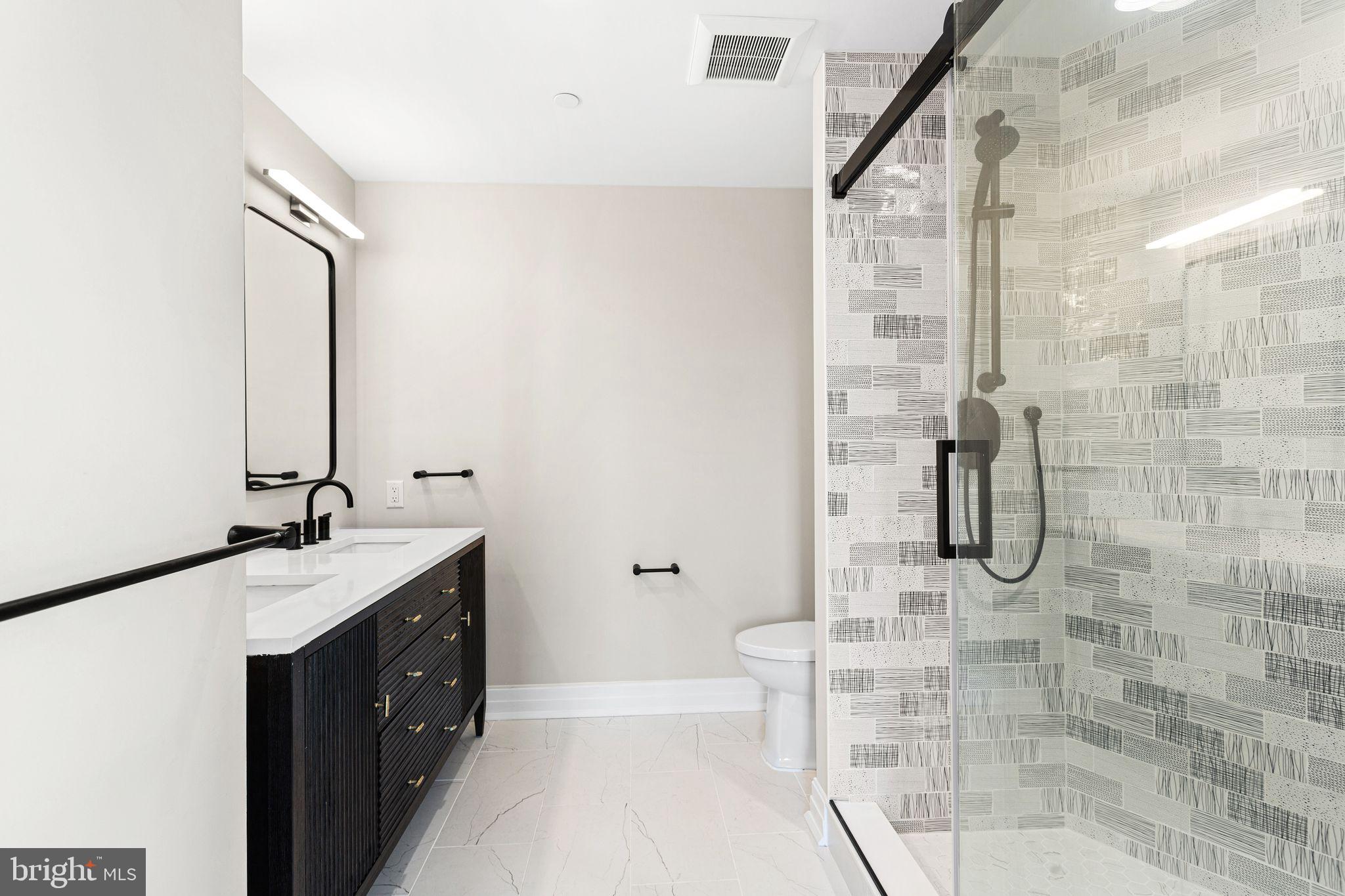 151 Kings Highway East, Unit B Haddonfield, NJ 08033 - Photo 10 of 23 a bathroom with a granite countertop sink a toilet and shower