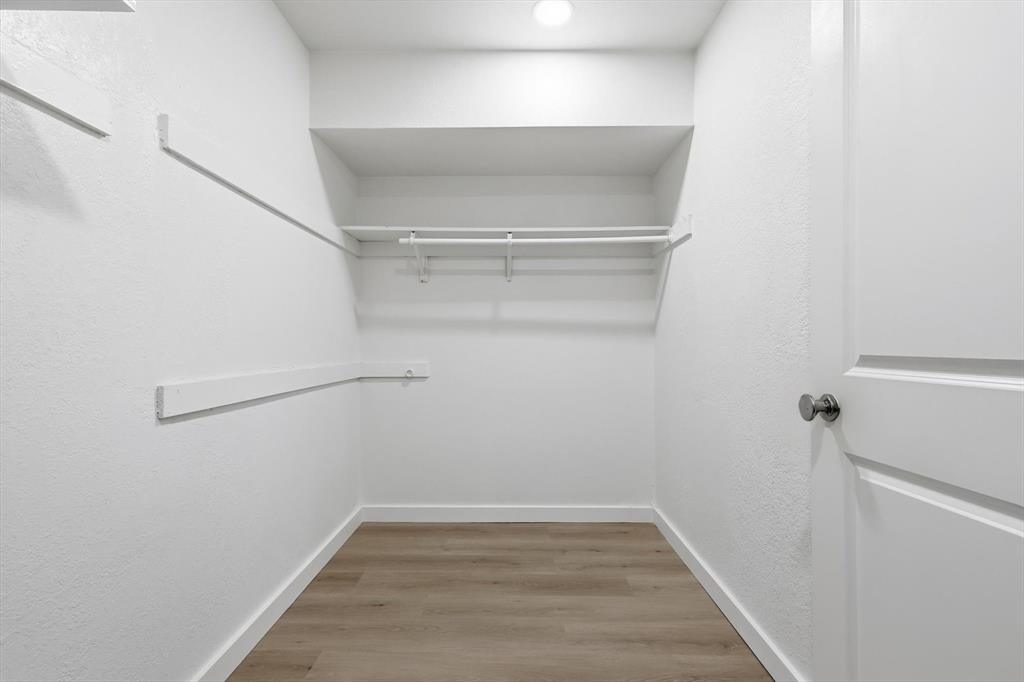 5940 Hunters View Lane Dallas, TX 75232 - Photo 13 of 24 Spacious closet featuring light wood finished floors