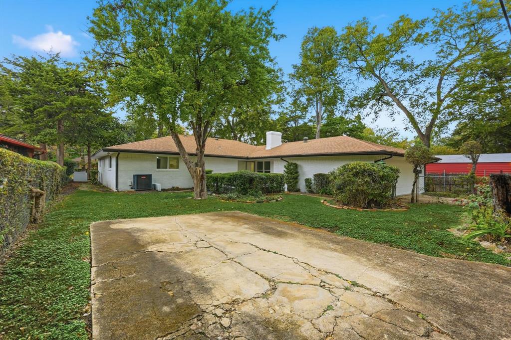 5940 Hunters View Lane Dallas, TX 75232 - Photo 18 of 24 Rear view of house with brick siding and a chimney