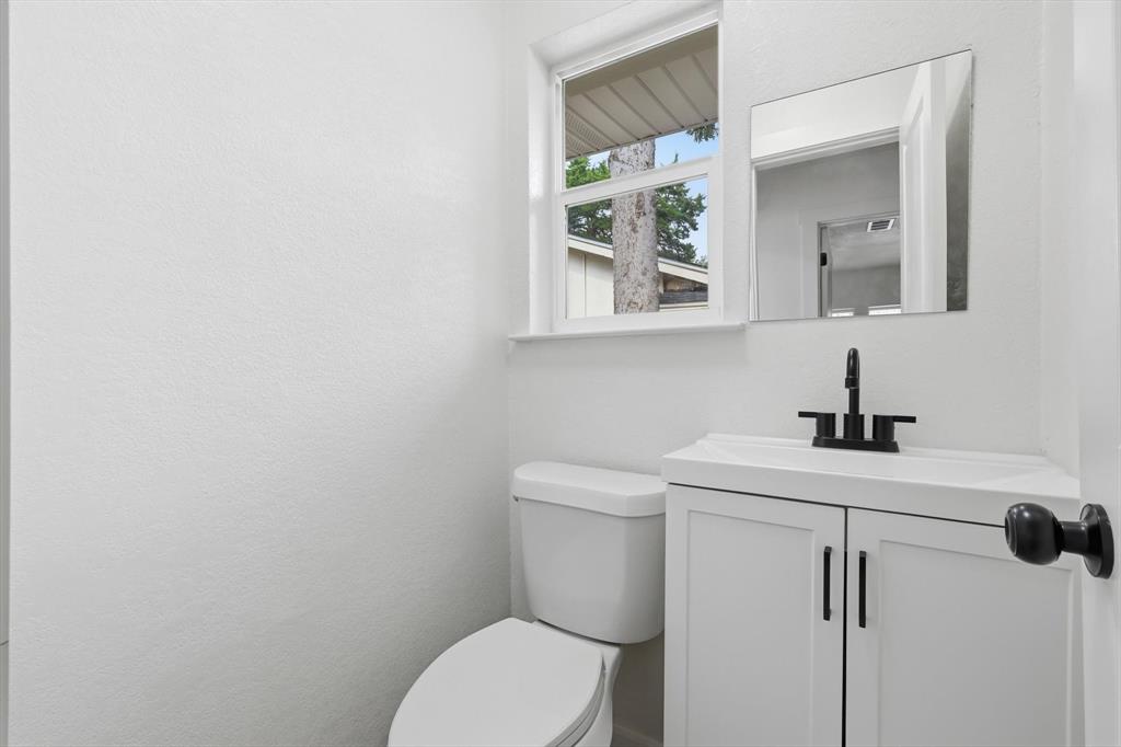 5940 Hunters View Lane Dallas, TX 75232 - Photo 7 of 24 Half bath featuring vanity and toilet