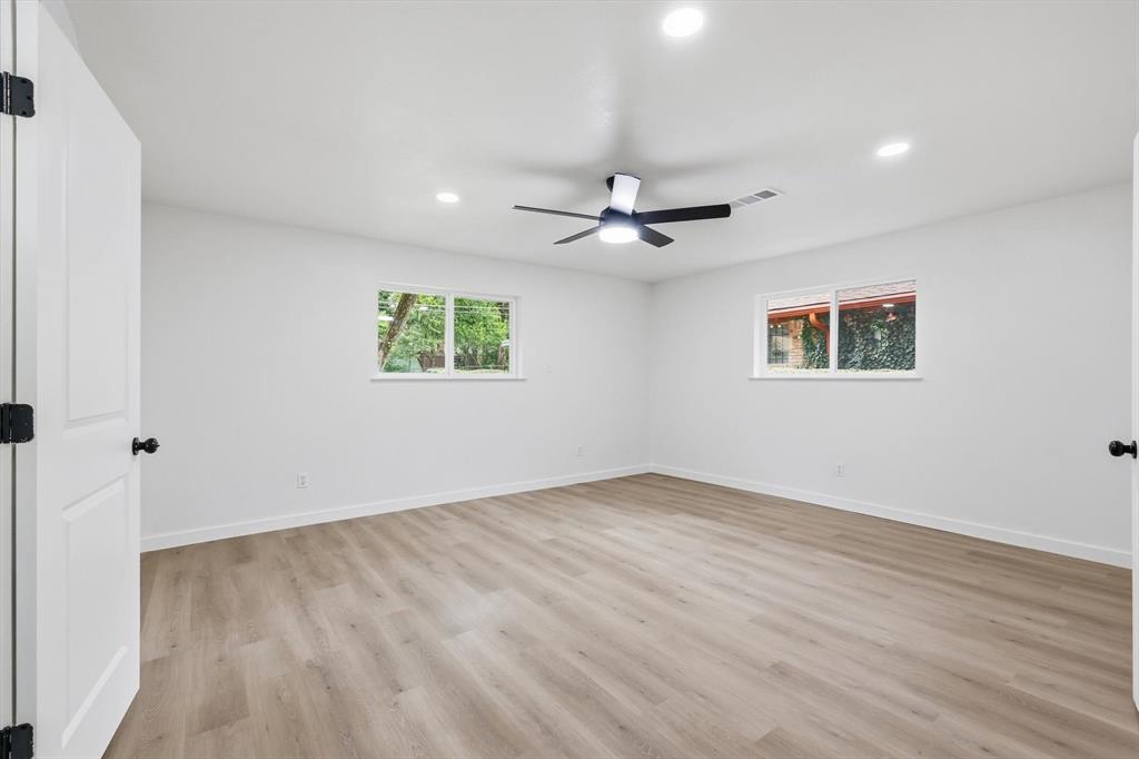 5940 Hunters View Lane Dallas, TX 75232 - Photo 10 of 24 Empty room with light wood-type flooring, recessed lighting, and a ceiling fan