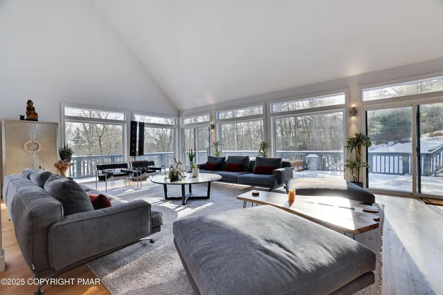 a dining room with furniture a chandelier and window