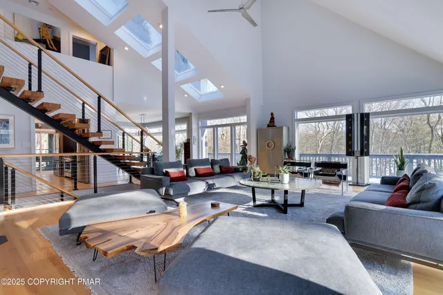a view of a dining room with furniture a chandelier and wooden floor